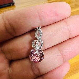 Elegant infinity pink crystal pendant with cubic zirconia accent